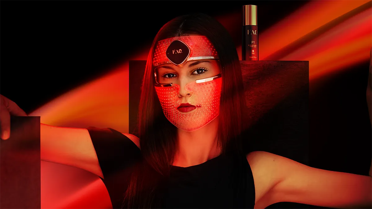 A woman using FAQ 202 LED face mask